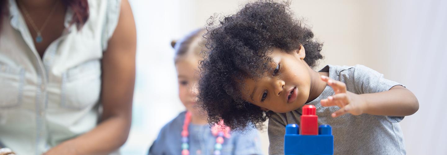 a young child plays with blocks