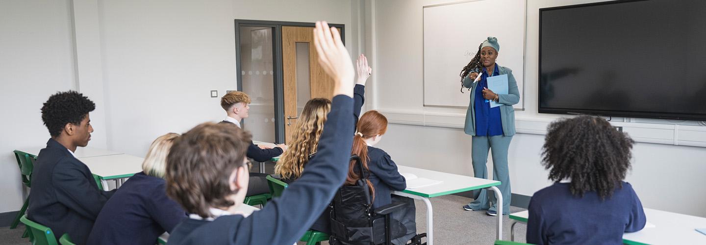 a student raises their hand in class