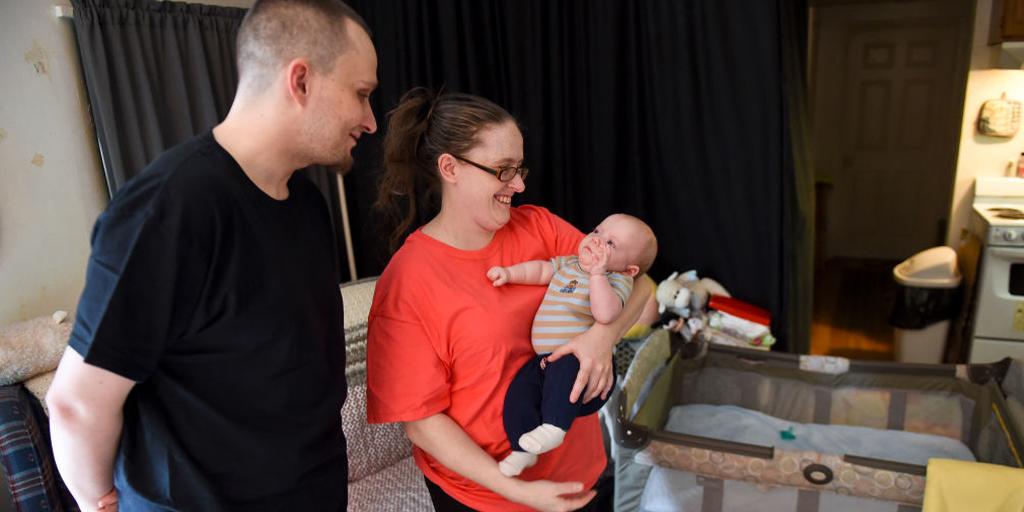 A couple holds their baby