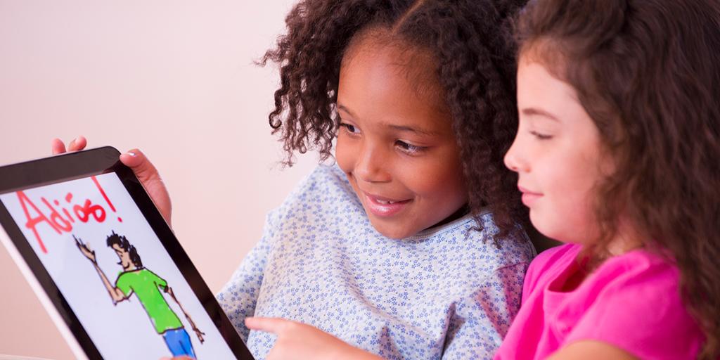 two young girls learn spanish