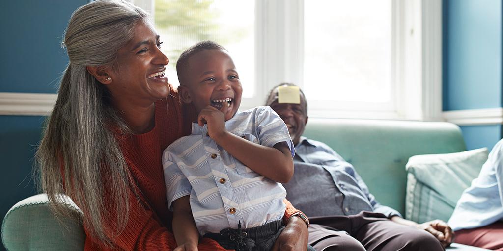 smiling grandmother holds grandchild