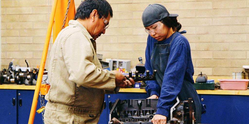 young woman and her teacher in shop class