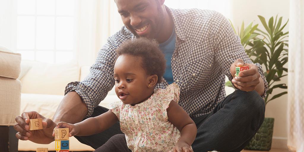 a father and daughter play together