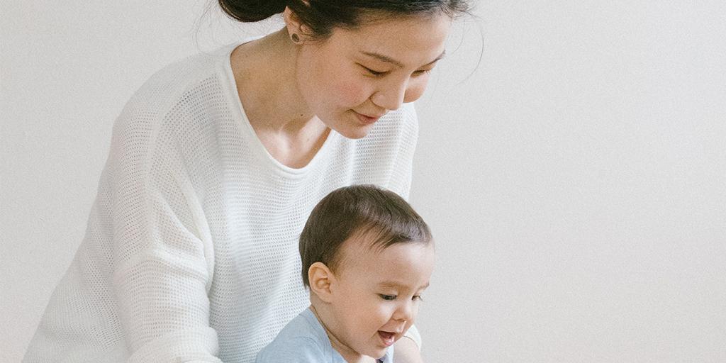 a woman holds her young child