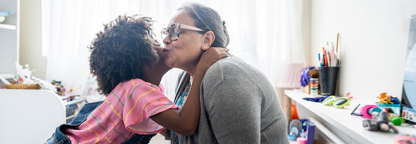 a girl hugs her grandmother